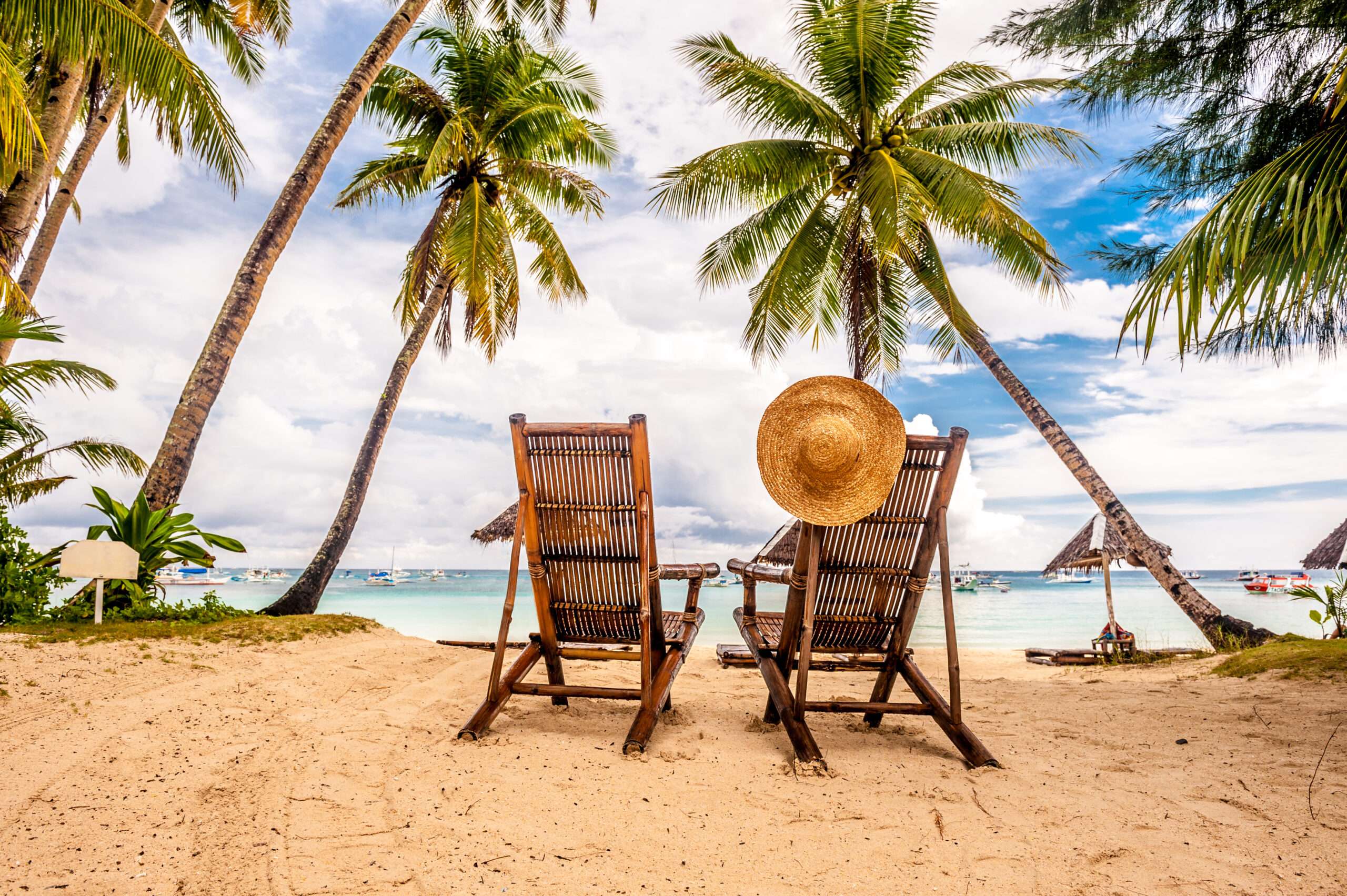 A beach with two chairs and palm trees. A representation of the benefits of a Florida Depression Treatment Center.