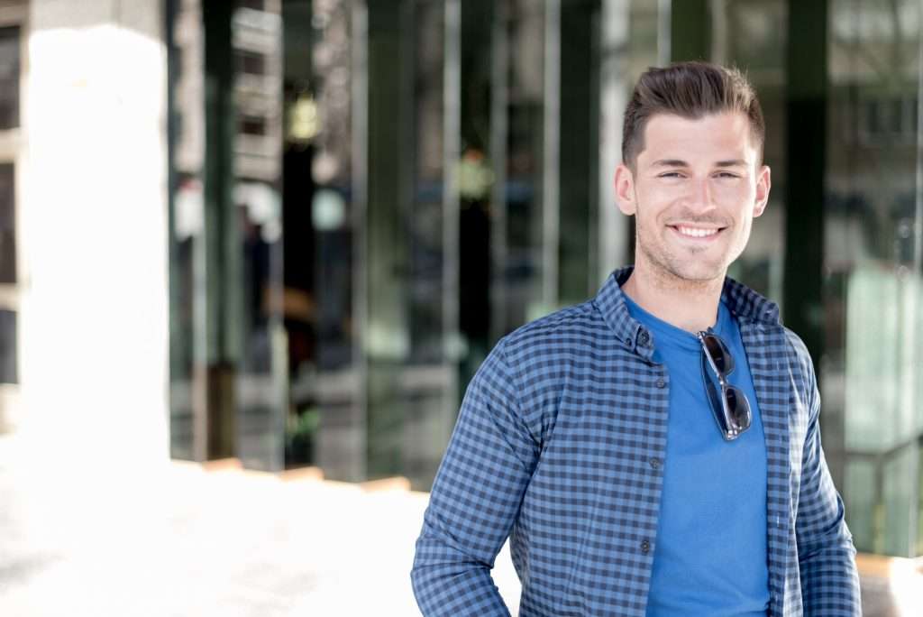 A young man smiling after treating depression to avoid a Lexapro Overdose