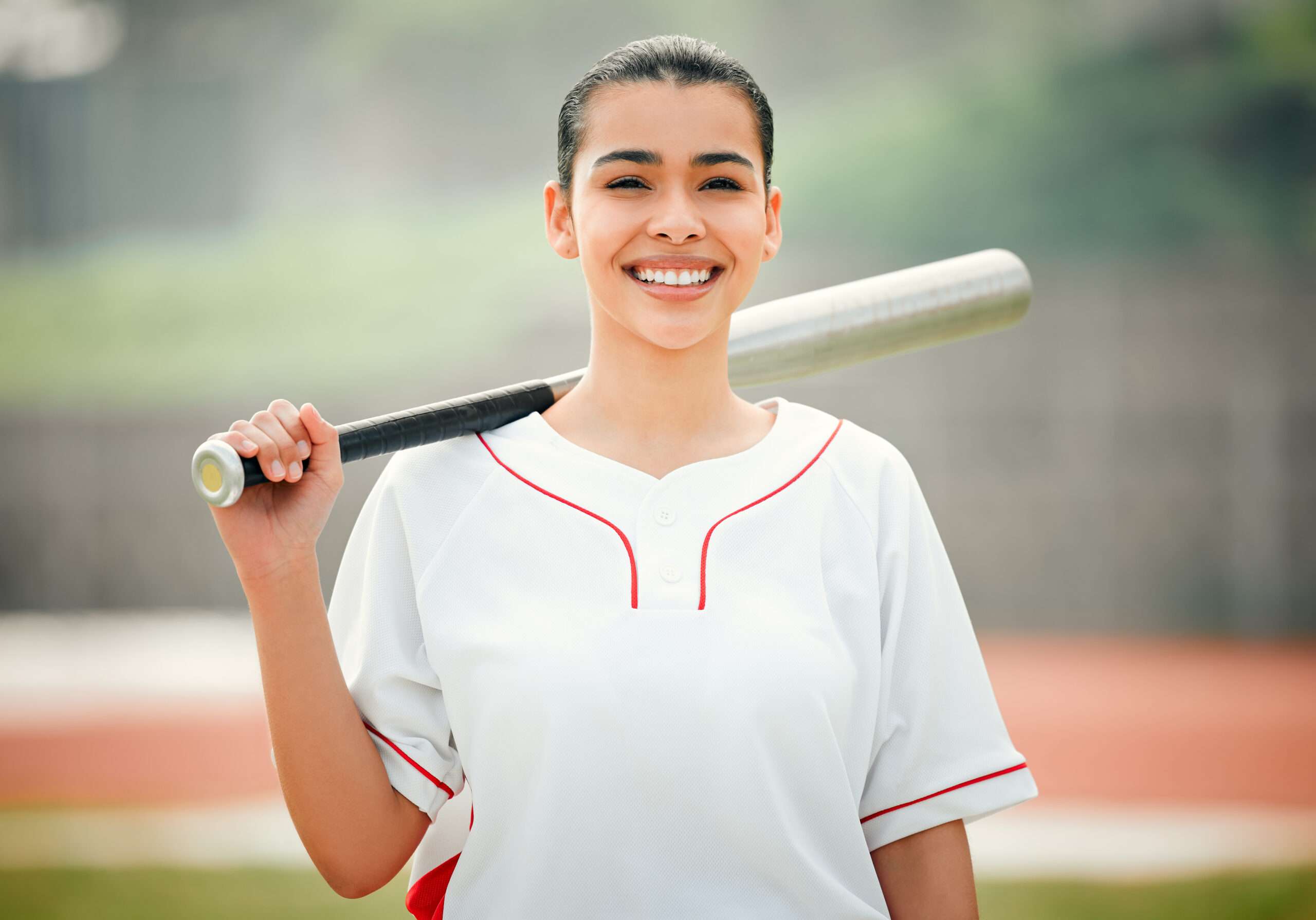 A woman with a bat getting ready to play mental health softball.